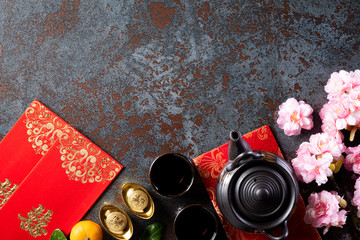 Chinese new year festival decorations pow or red packet, orange and gold ingots or golden lump on a...