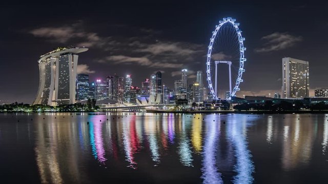 TL/ZI Asia, Singapore, night to day transition, zoom in time lapse of the financial district and Singapore skyline at dawn, showing Marina Bay Sands and Singapore flyer in foreground.