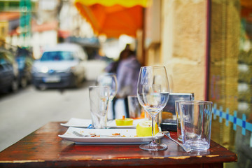 Fototapeta premium Empty wine glasses on street bar table in San Sebastian, Spain