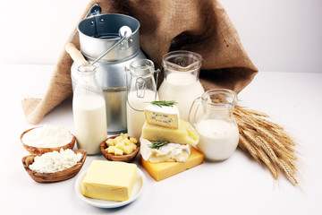 Different  healthy dairy products on rustic background with milk, cheese, butter and cottage