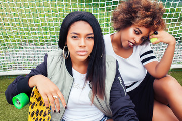 young pretty multi ethnicity afro-american girls having fun on foothball field, fan club of swag teenagers