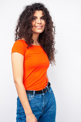 young brunette woman with curly hairstyle in bright casual clothers isolated on white background gesturing happy smiling, lifestyle people concept
