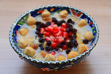 Turkish dessert ashura on wooden table.