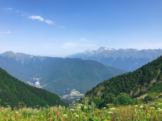 Fototapeta na wymiar Beautiful view from the peak of Caucasus mountains. Roza Khutor, Russia