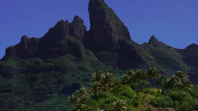 Slow motion drone low angle shot. Mountain Otemanu in Bora Bora, Tahiti French Polynesia. Paradise travel vacation & romantic getaway, honeymoon exotic destination.  
