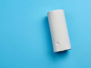 twisted roll of white paper towel on a blue background