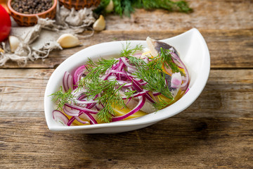 Herring with potatoes on wooden table