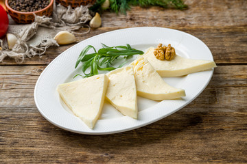 Suluguni cheese sliced on a plate