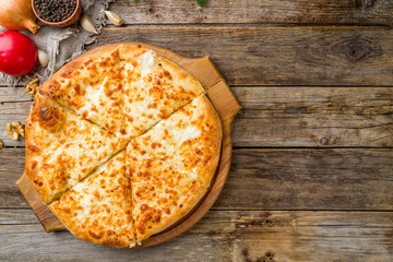 khachapuri with cheese on wooden table