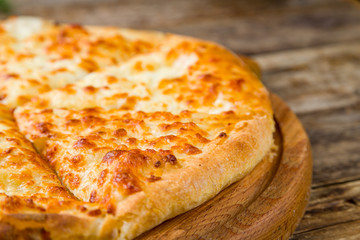 khachapuri with cheese on wooden table