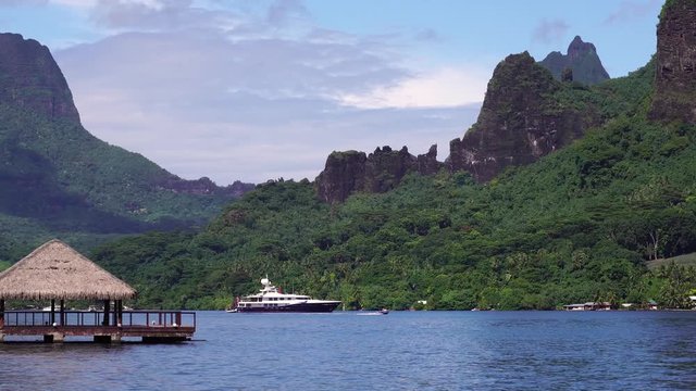 Luxury yacht in Cooks bay. Moorea, Tahiti French Polynesia. Tropical vacation paradise island with lagoon beach. Luxury travel vacation & paradise getaway, romantic honeymoon exotic destination.  