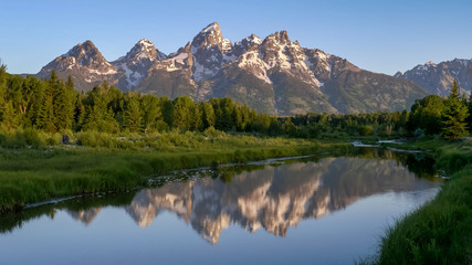 reflection of grand teton at schwabacher landing in the morning