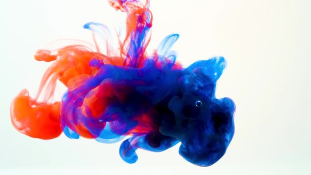 Color paint drops in water , abstract color mix , drop of Ink color mix paint falling on water Colorful ink in water, 4K footage,