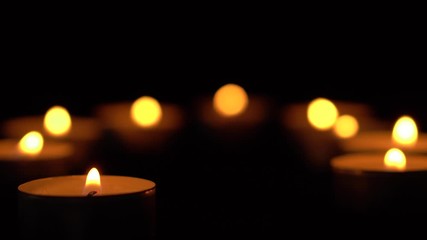 Slow motion white candles light up flames fire on isolated black background. Use in romantic dinner, warm and relax peace maditaion, use for spiritual religion church decotion and Halloween graveyard