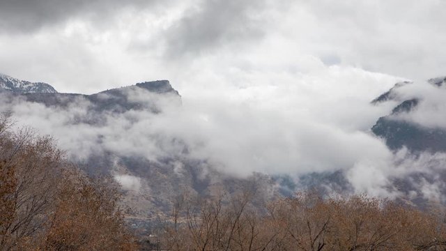 Time lapse of clouds moving over mountain range after rainstorm in Utah.