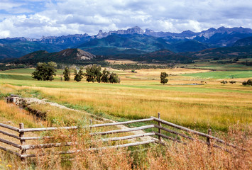 Fototapeta na wymiar Zig-Zig Rail Fence and San Juan Mountains, Ridgeway, Colorado