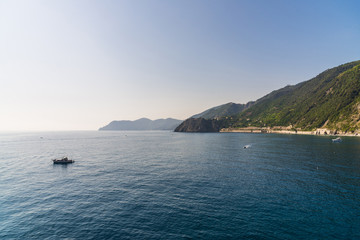 View at Ligurian Sea coastline in Liguria, Italy, with aquamarine transparent water and boats
