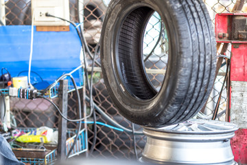 Fototapeta premium Blurred up close view of car maintenance, tire changing, disk brake cleaning, for the safety of the driver and maintenance according to the use.
