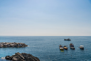 Fototapeta na wymiar View at Ligurian Sea coastline in Liguria, Italy, with aquamarine transparent water and boats