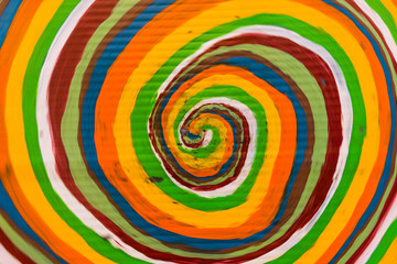Fototapeta na wymiar Abstract background of colorful lollipop spiral. Selective focus at the centre of the image.