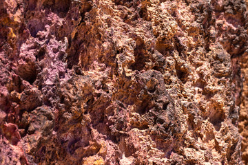 Red rocky surface similar to the planet Mars. Red rocks illuminated by the sun.