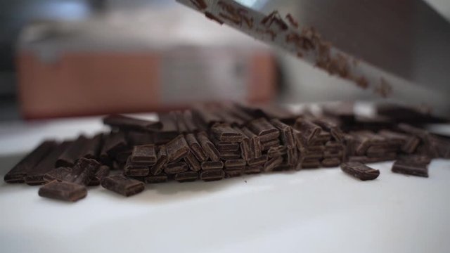 Cutting chocolate batons with a really sharp knife.
