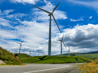 Modern concrete Wind farm and turbines generating electricity in nature's vibrant lush grazing...