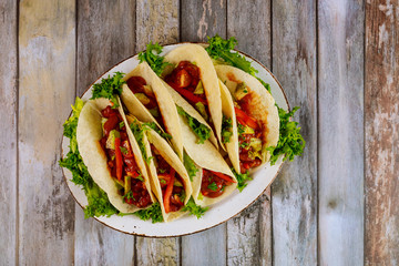 Soft corn tortillas with chili beans, beef and vegetable.