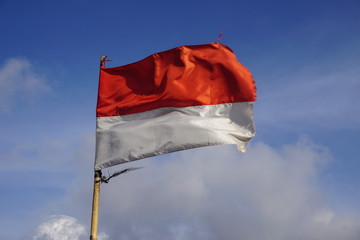 Indonesia Waving Flag on Blue Sky Photo