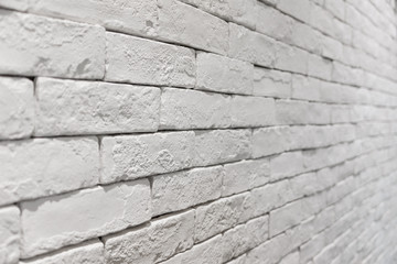 side view of empty white brick wall in room. textured and background