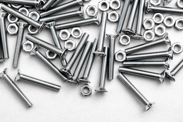 Top view of stainless steel bolts or iron nails on brigth white background with silver color. Metal screws for use in sheet metal.