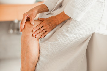 Fototapeta na wymiar Elderly woman feeling pain in her knee