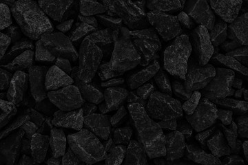Natural fire ashes with dark grey black coals texture. It is a flammable black hard rock. Space for text.