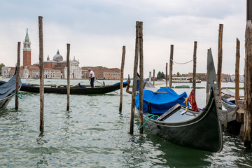 Obraz na płótnie Canvas Jetty with gondolas on the Venice promenade