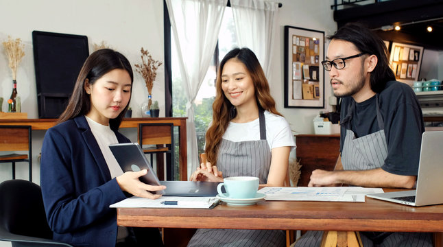 Young asian business woman discussing about financial planning with small business owner at cafe coffee shop, Business meeting corporate partnership, financal loan for start up business