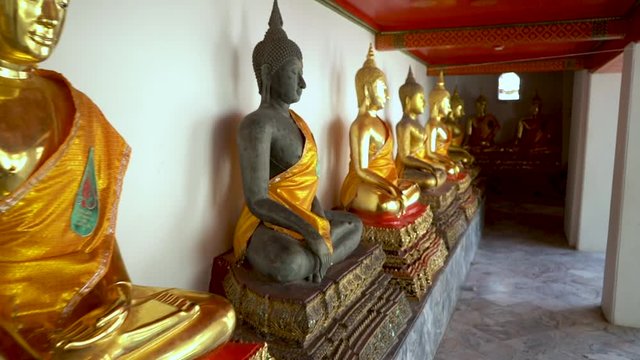 Row of beautiful Buddha Statues at Wat Pho in Bangkok, Thailand.