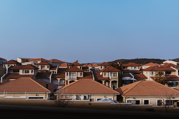 many similar residential houses in Africa under blue sky