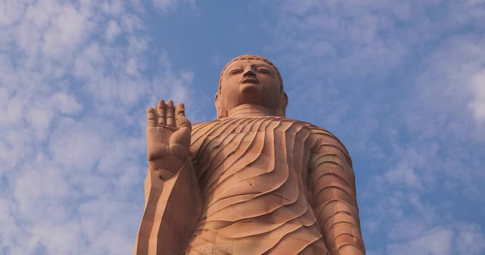 Close up shot of tall Buddha statue in Sarnath temple in Varanasi, Uttar Pradesh, India