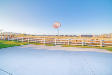 Empty all weather exterior basketball court on a sunny day