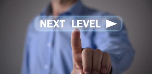 Man touching Next Level text. Business concept