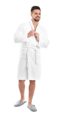 Handsome man wearing bathrobe on white background
