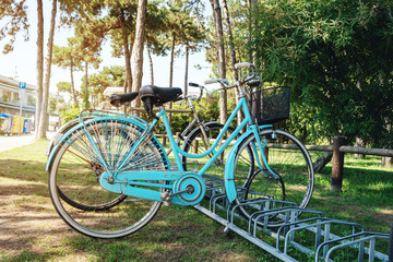 Fototapeta na wymiar old blue bike parked in town
