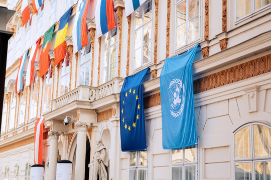 Set Of European Union Flag And United Nations Flags Hanging On Building In Vienna, Austria, Europe