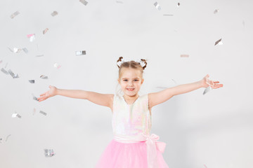 Party, holidays, birthday, new year and celebration concept - Cute child throwing confetti.