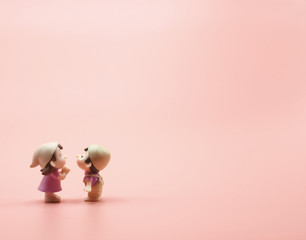 The pink background wallpaper copy space has two red heart. Left image girl and boy doll toy romantic happy lover kissing in 14 fourteen feb or february happy Valentine day for wedding and engagement  - obrazy, fototapety, plakaty