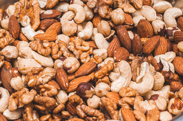Background of assorted cashews, almonds, greta and hazelnuts mixed closeup. Healthy and wholesome...