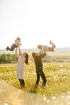 Happy young family spending time together outside in green nature
