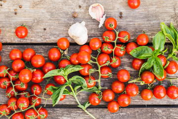 Fresh cherry tomatoes on a wooden table.