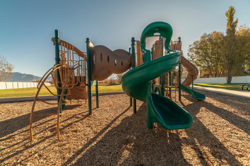 Kids playground at sunset with twist slide