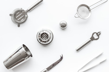 Bartender equipment set with shaker and stainer on white background top-down pattern